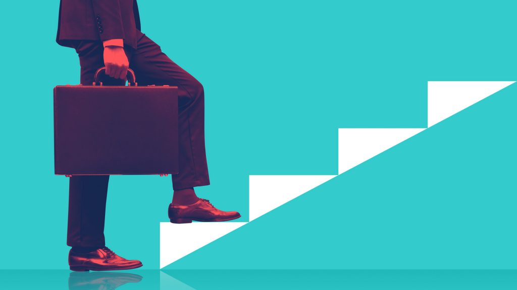 businessman holding briefcase walking on graphic stairs